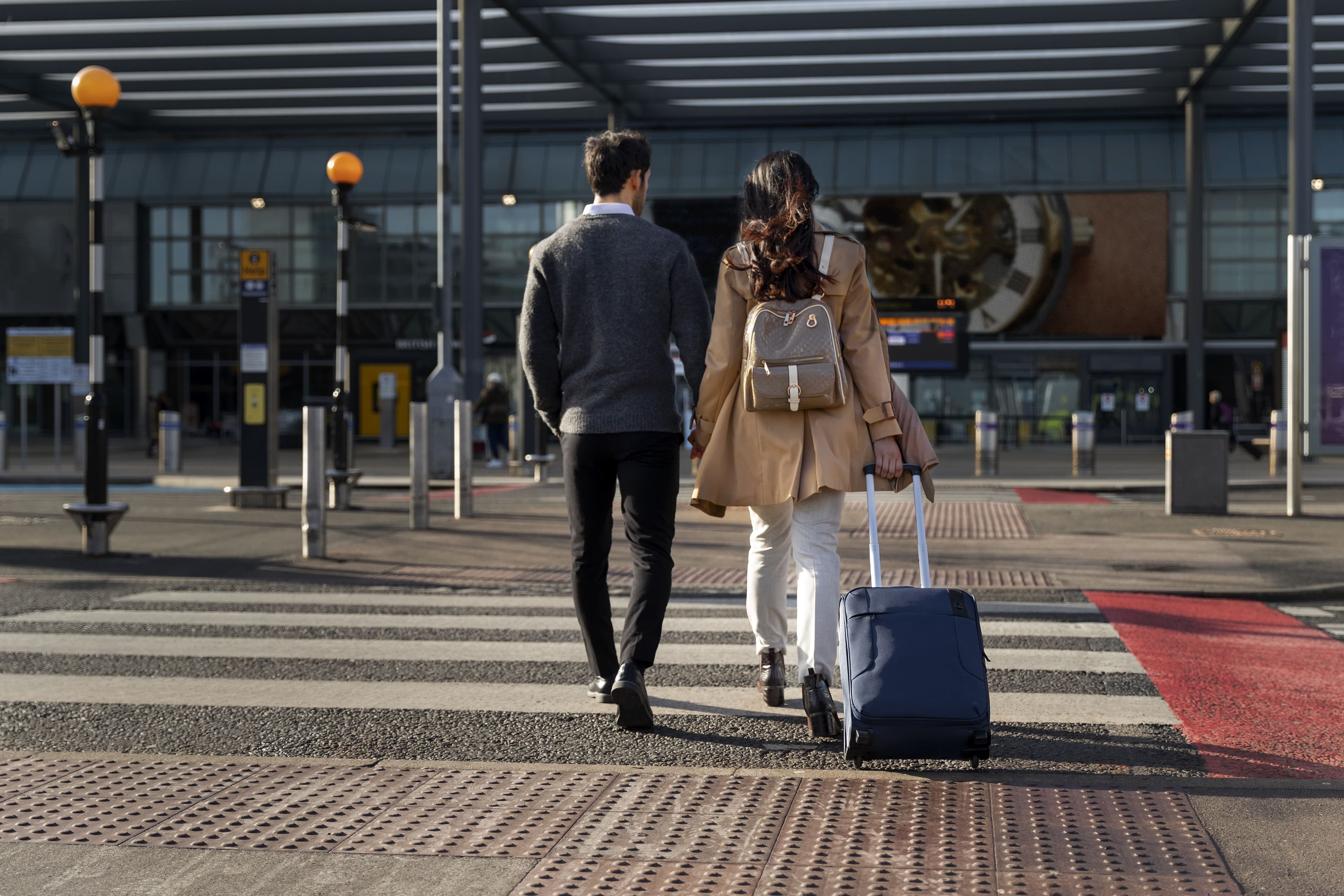 Couple holding hands before departure transfer